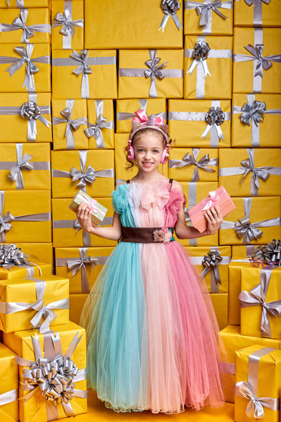 cute positive happy little female child wearing party dress holding gift box and having fun - Fotoğraf, Görsel