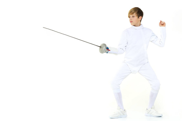 Boy fencer standing in attacking pose - 写真・画像