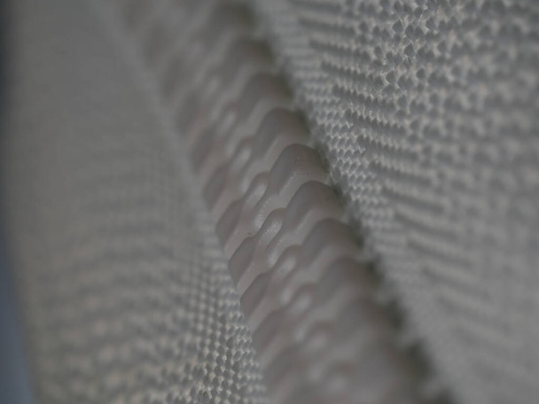 A closeup shot of a zipper of a cloth - Photo, Image