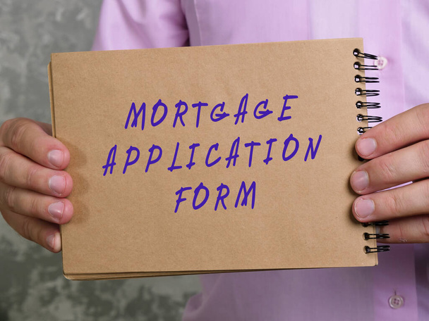 Business concept meaning MORTGAGE APPLICATION FORM with phrase on the sheet. - 写真・画像