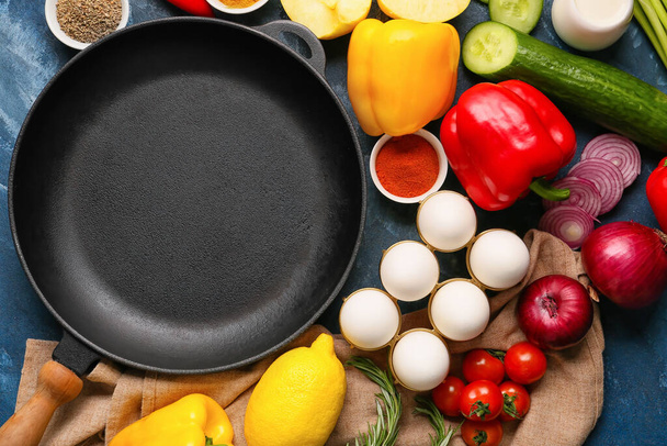Чистый сковородка с продуктами на цветном фоне - Фото, изображение
