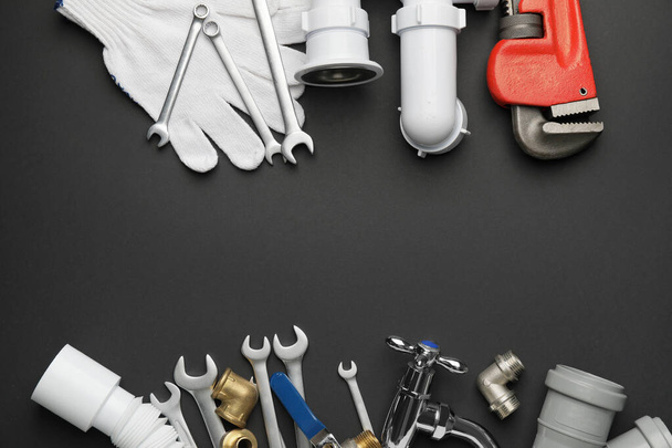 Set of plumber's items on dark background - Photo, Image
