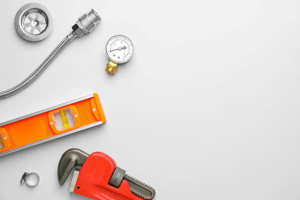 Set of plumber's items on light background - Foto, immagini