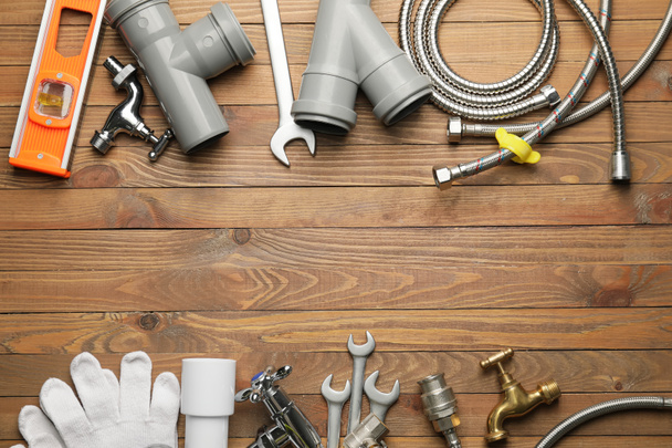 Set of plumber's items on wooden background - Photo, Image