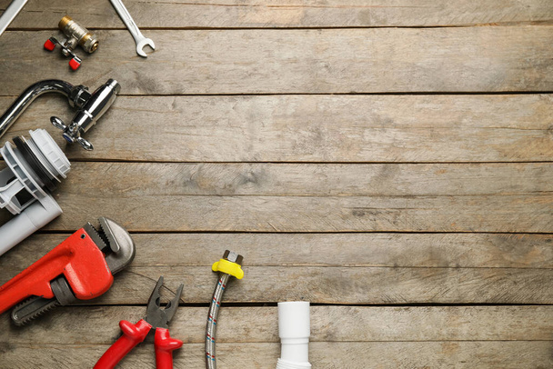 Set of plumber's items on wooden background - Foto, immagini