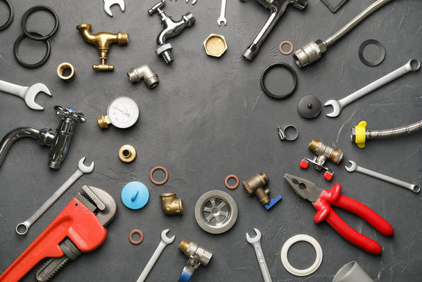 Frame made of plumber's items on dark background - Photo, Image