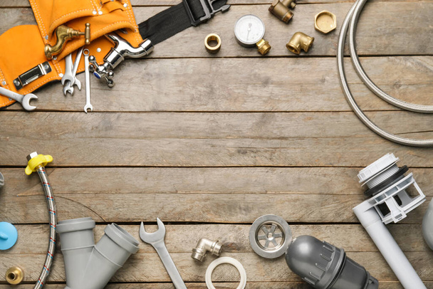 Frame made of plumber's items on wooden background - Photo, Image