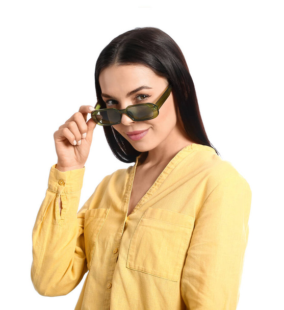 Beautiful young woman wearing stylish sunglasses on white background - Photo, Image