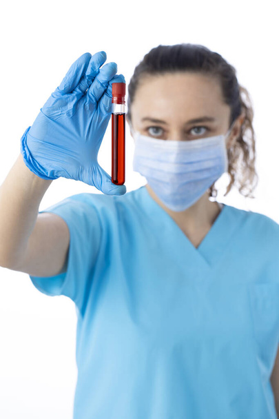 Doctor holding blood tube test on isolated white background. Coronavirus testing. Doctor taking a blood sample tube - Photo, image