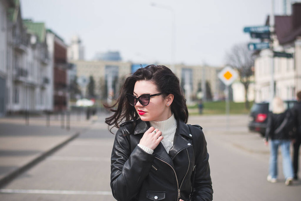 lifestyle fashion portrait of young stylish hipster woman walking on the street - Photo, image