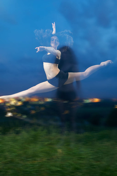 pretty, young, smiling dancer performs splits in the air - Photo, image