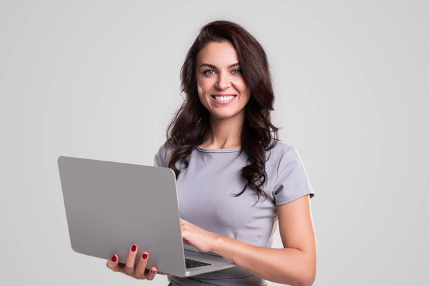 Cheerful female manager using laptop - Zdjęcie, obraz