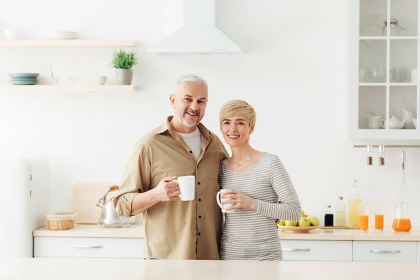 Romantic morning, happy relationship and adult couple drinking coffee at home - Fotoğraf, Görsel