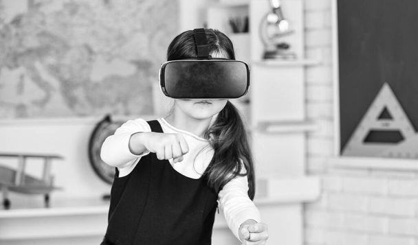 Virtual classes. Driving lessons. Science Class. VR technology. schoolgirl using virtual reality helmet. Virtual reality headset. Teenager student girl in classroom. Play game. Go around obstacles - Foto, Imagem