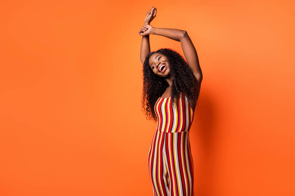 Photo of happy nice pretty afro american young lady raise hands dancer isolated on orange color background - Φωτογραφία, εικόνα