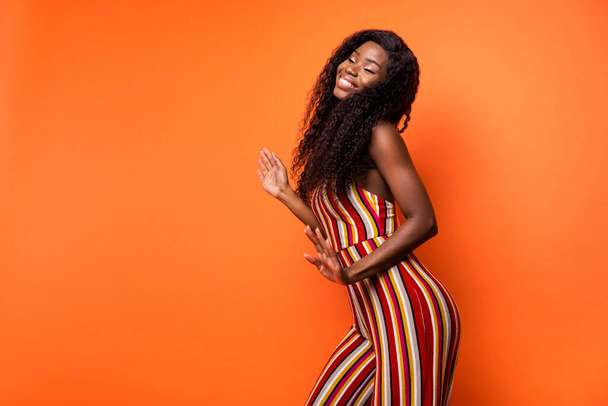 Profile side photo of dark skin attractive happy lady dance dream summer isolated on orange color background - Photo, image