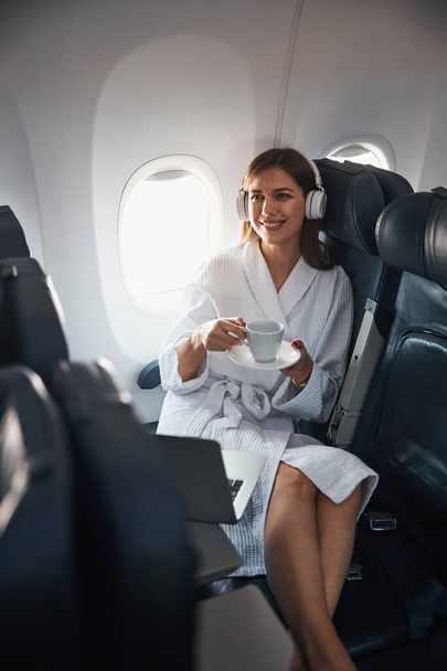 Positive plane passenger putting cup on saucer - Photo, image