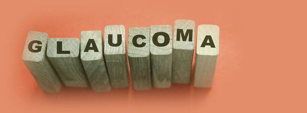 Glaucoma word made with wooden blocks, eye healthcare medical concept. - Foto, afbeelding