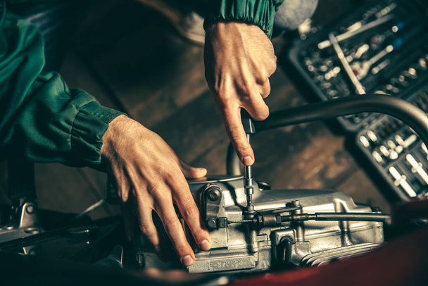 Motorcycle repair. Male hands with tool close up - Photo, Image