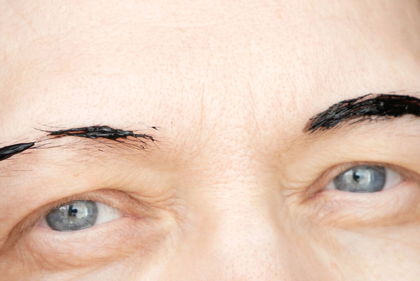 Korrektur der Augenbrauen und Modellierung zu Hause, Augenbrauen färben Henna-Tätowierung, Permanent Make-up, Nahaufnahme - Foto, Bild
