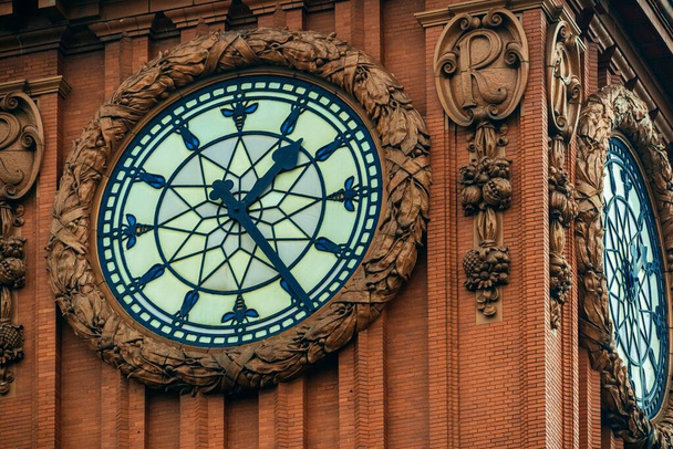Vintage clock closeup view in Manchester street in England, United Kingdom - Fotó, kép