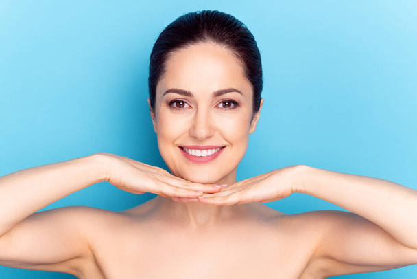 Photo of young attractive woman happy positive hands touch chin plastic surgery correction isolated over blue color background - Φωτογραφία, εικόνα