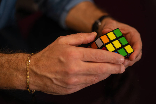 SANTA MARIA CAPUA VETERE, ITALY - Feb 01, 2021: Caserta, Italy, January 31th 2021, Rubik's cube in the hands close up. It was invented by Hungarian architect Erno Rubik in 1974. - Fotografie, Obrázek
