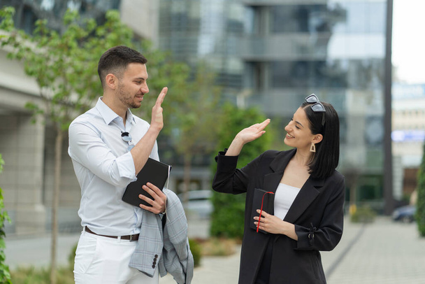 Two business people are giving each other a high five for the success - Photo, Image