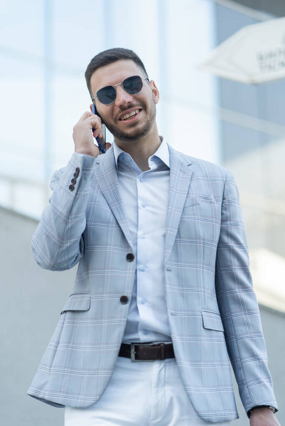 Handsome and attractive businessman is hearing a great news about his business - Foto, imagen