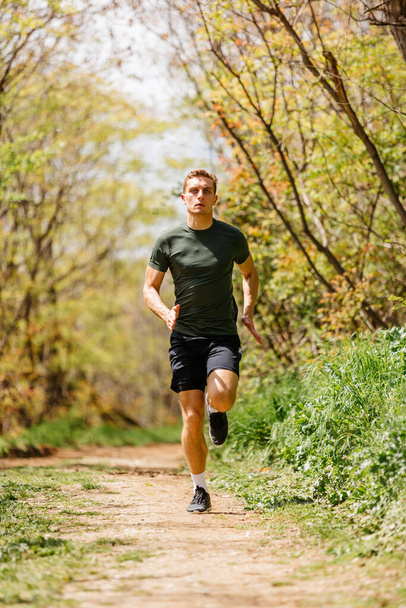 Sport man running. Portrait of runner man jogging in park. Sport workout outdoor. Athlete training run exercise - Foto, Bild