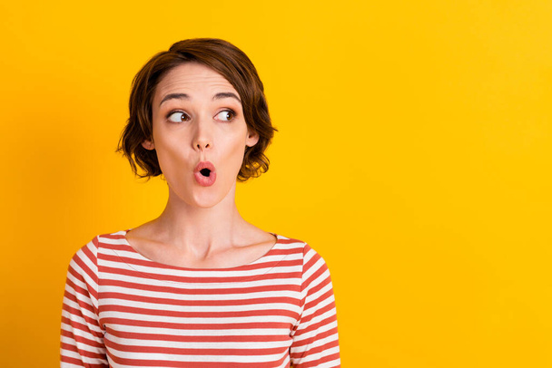 Close up portrait of shocked person unexpected news open mouth watch empty space isolated on yellow color background - Zdjęcie, obraz