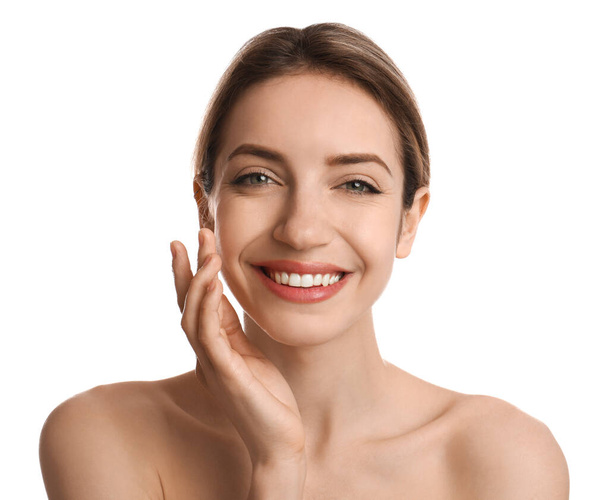 Young woman applying facial cream on white background - Foto, Bild