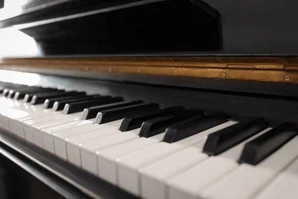 Modern piano with black and white keys, closeup - 写真・画像