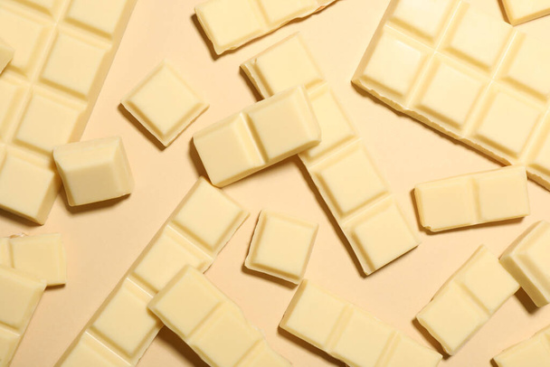 Delicious white chocolate on beige background, flat lay - Fotografie, Obrázek