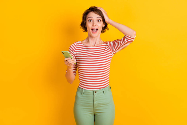 Photo of attractive lady cant believe open mouth arm on head isolated on vivid yellow color background - Photo, Image