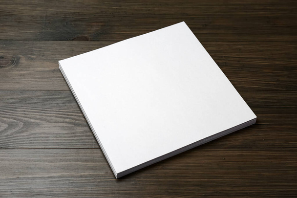 Stack of blank paper sheets on wooden table. Brochure design - Фото, зображення