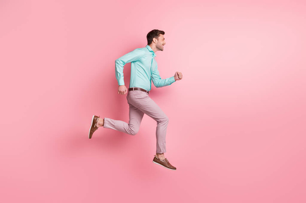 Full size profile side photo of young brunette man jump up air run hurry copyspace sale isolated on pastel pink color background - 写真・画像