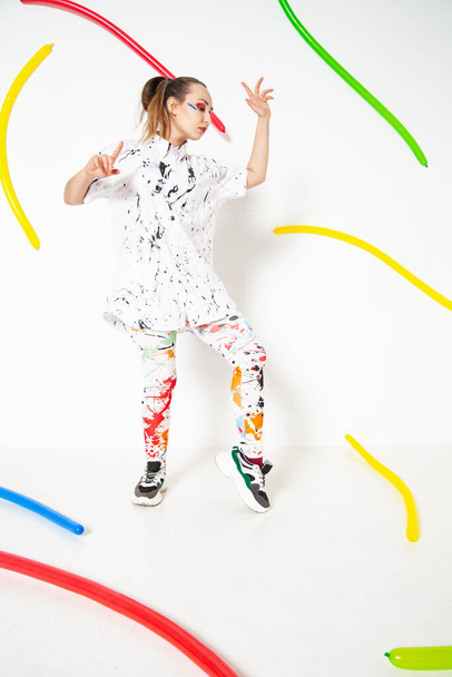 Creative woman in white clothes stained with colorful paint - Fotografie, Obrázek