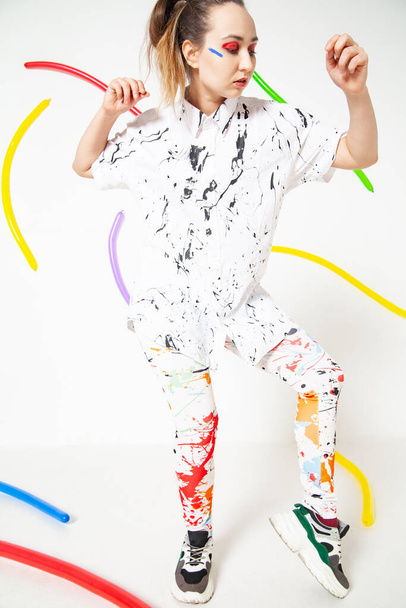 Creative woman in white clothes stained with colorful paint - Fotografie, Obrázek