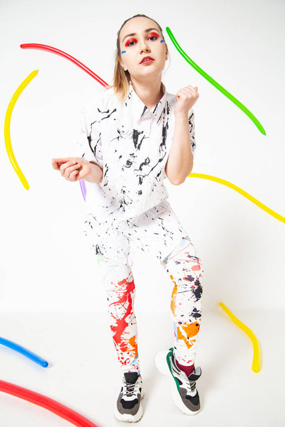 Creative woman in white clothes stained with colorful paint - Foto, Imagem