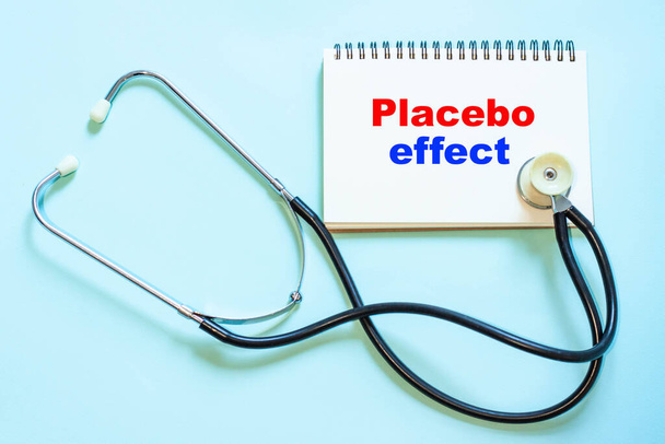 Placebo effect, medical text on stethoscope background - Foto, Imagem