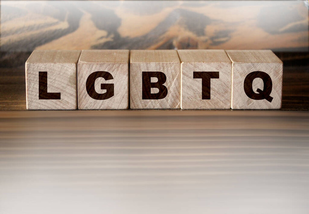 LGBTQ letters wooden cubes letters, on wooden background. - Photo, Image