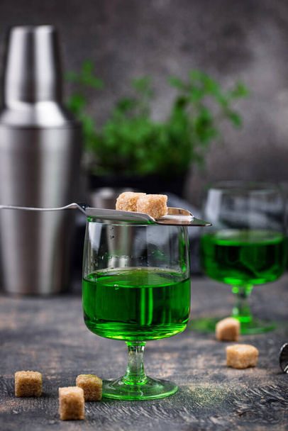 Glass of absinthe with cane sugar - 写真・画像