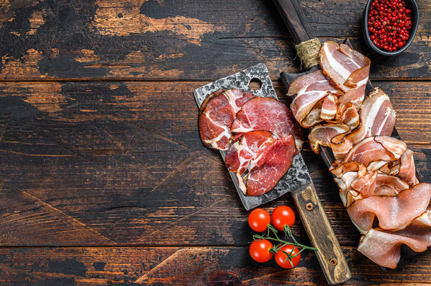 Meat antipasto board, pancetta, salami, sliced ham, sausage, prosciutto, bacon with grape and parmesan cheese. Wooden background. Top view. Copy space - Valokuva, kuva