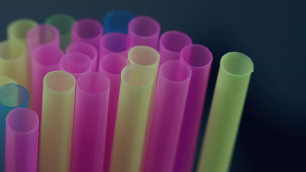 Multicolored straws for drinks, close up, camera movement, dark background - Footage, Video