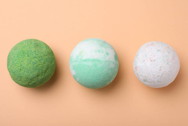 Colorful bath bombs on beige background, flat lay - Foto, afbeelding