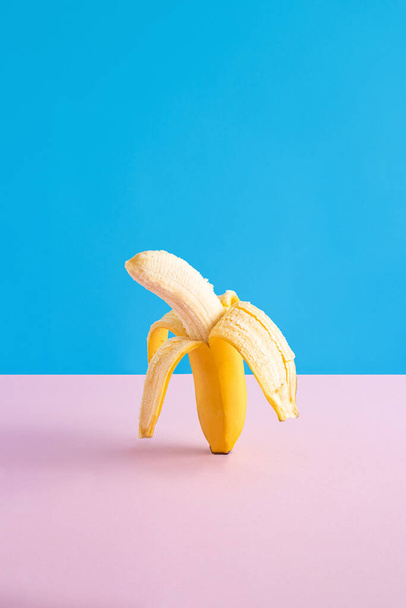 Mise en page de fête tropicale créative avec banane jaune pelée. Fond abstrait de l'art des couleurs. Concept d'été minimal. - Photo, image