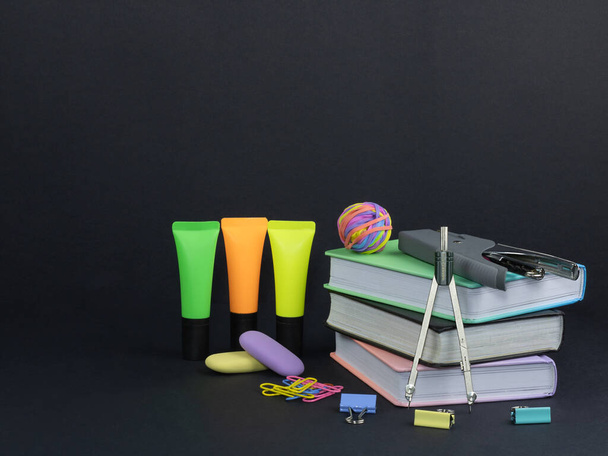 Stack of colored books and school supply. Back to school:, book, stapler, felt tip pen. - Photo, Image