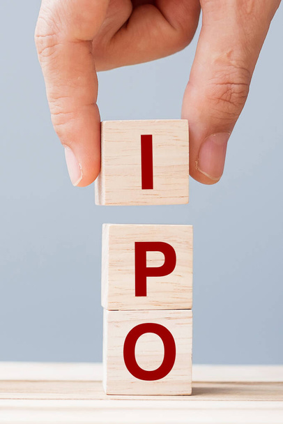 IPO (Initial Public Offering) word with wooden cube block, shares of a private corporation to the public in a new stock issuance. Stock, Fund, Investors and Investment concept - Photo, Image