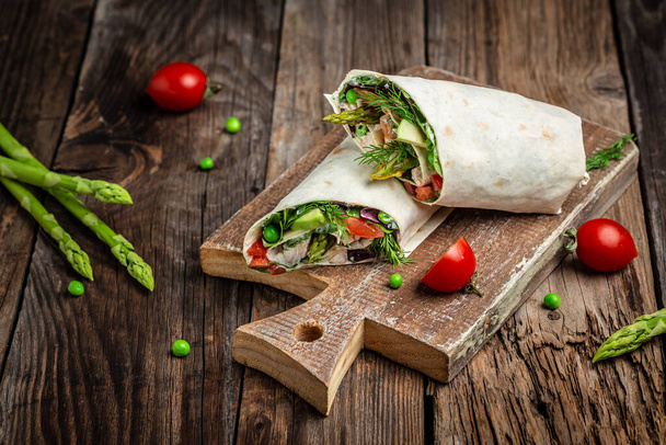 Wraps with chicken and asparagus, avocado, tomatoes, peas, cheese and tartar sauce. Outdoors Food Concept. - Photo, Image